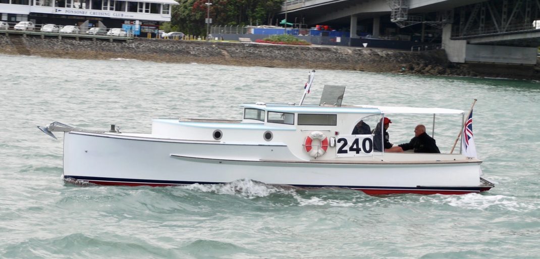 A snapshot photograph of a classic launch yacht supplied by the owner